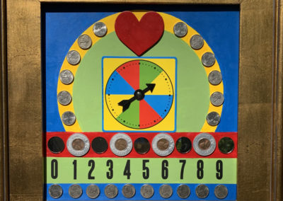 Cilla, Sheehan, Lucky in Love, Assemblage of found materials on board, 17”x 17”, The spinner represents your chances at finding a loving life partner, only one of which will be lucky. The coins represent the slot machine of life.